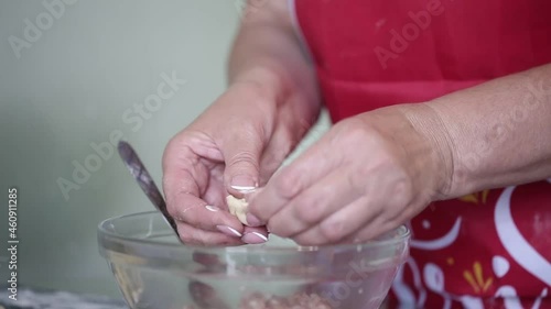 a woman makes homemade dumplings in the kitchen