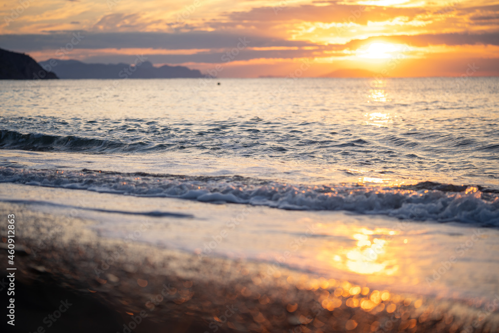 Amazing sunrise over the tropical beach. Yellow sun over sea. Orange colors waves. Nature background. Beautiful serene scene. Morning. Sunlight reflect on water surface Amazing sunrise over the tropical beach. Yellow sun over sea. Orange colors waves. Nature background. Beautiful serene scene. Morning. Sunlight reflect on water surface