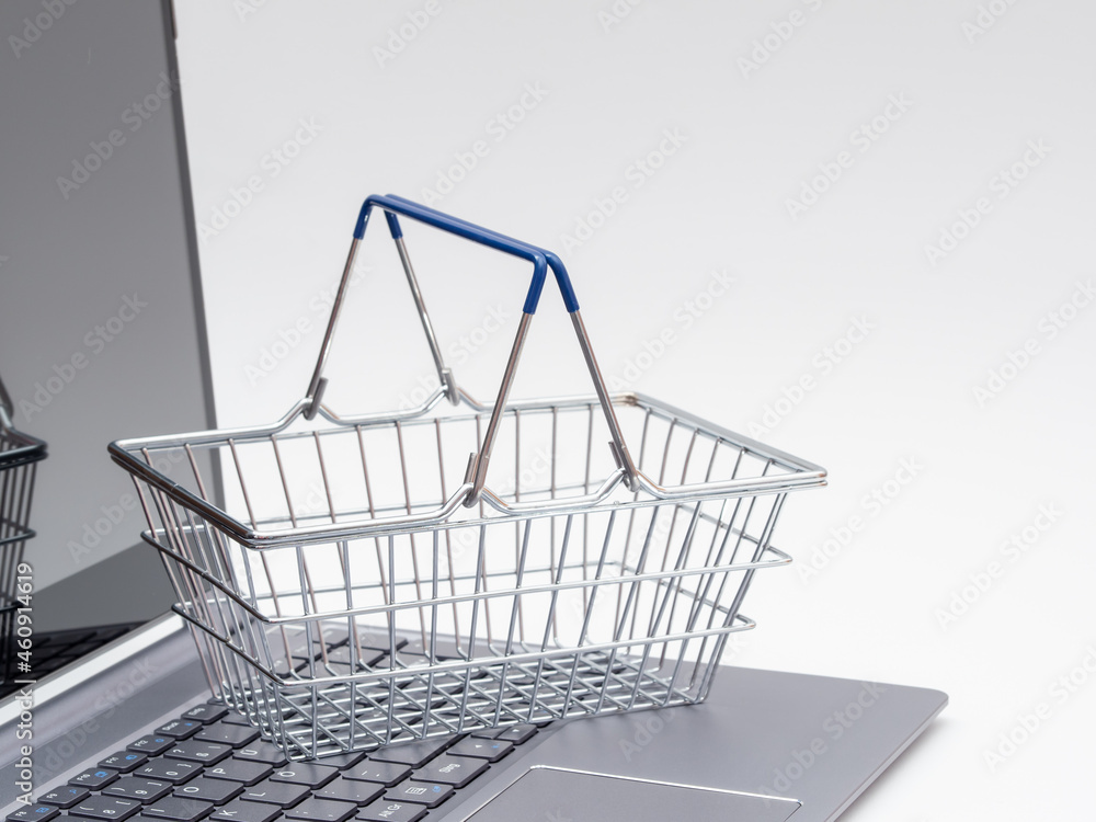 Shopping basket on laptop keyboard on white background, online store concept. Shopping basket on laptop keyboard on white background, online store concept.