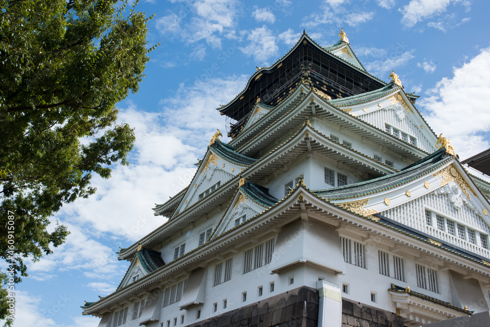 Close up of the facade of the Osaka castle. Blue sky with clouds. Osaka, Japan Close up of the facade of the Osaka castle. Blue sky with clouds. Osaka, Japan