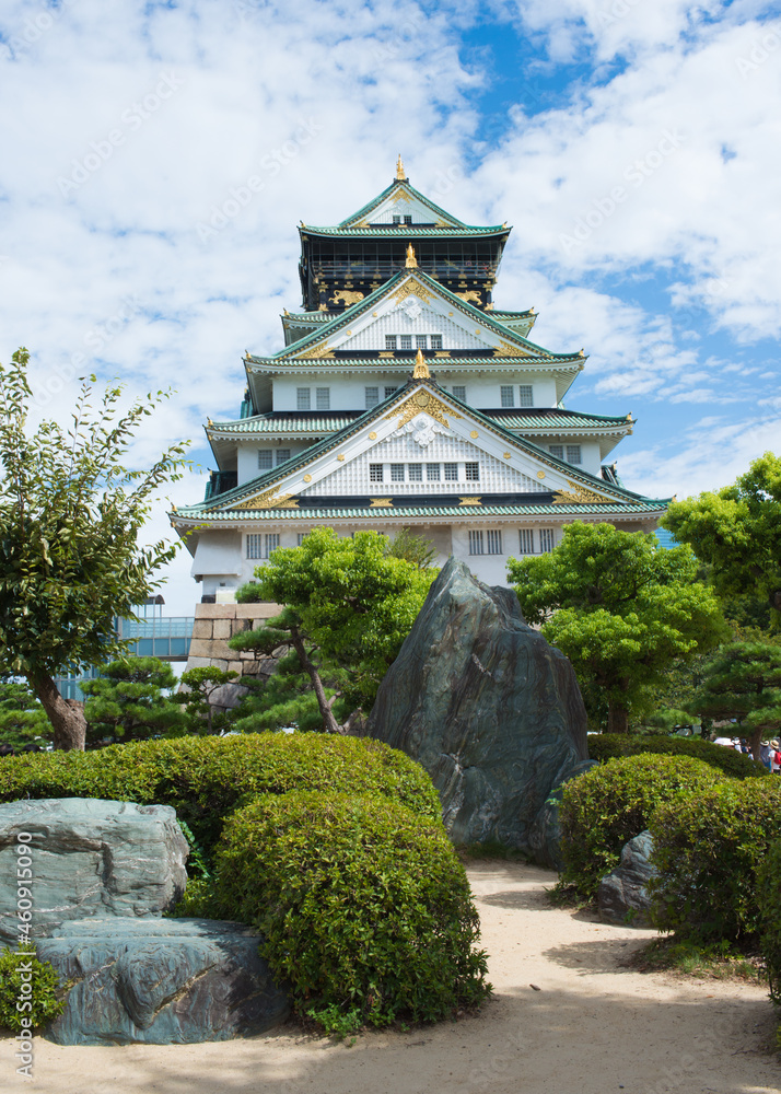 Fototapeta premium Beautiful view of the Osaka castle and garden around. Blue sky with clouds. Osaka, Japan