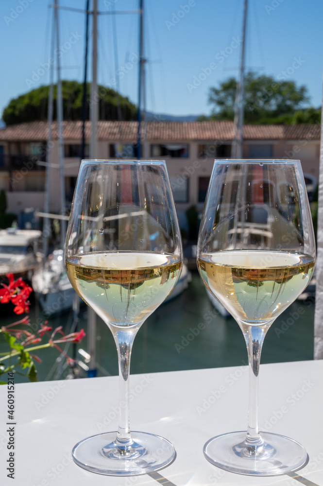 Summer on French Riviera Cote d'Azur, drinking cold dry white wine from Cotes de Provence on outdoor terrase in Port Grimaud, Var, France Summer on French Riviera Cote d'Azur, drinking cold dry white wine from Cotes de Provence on outdoor terrase in Port Grimaud, Var, France
