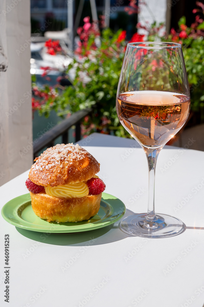 Tarte tropezienne or La Tarte de Saint-Tropez - dessert pastry consisting of filled brioche with cream and fresh berries.and glass of rose wine from Provence, France Tarte tropezienne or La Tarte de Saint-Tropez - dessert pastry consisting of filled brioche with cream and fresh berries.and glass of rose wine from Provence, France