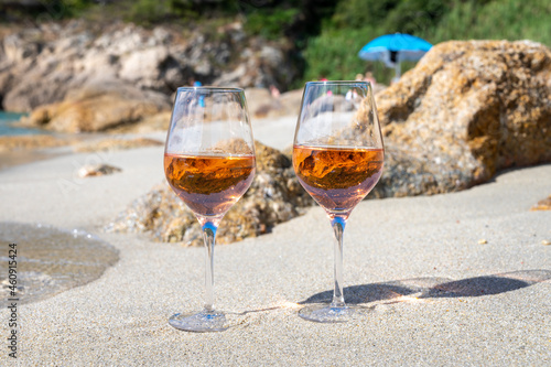 Summer time in Provence, two glasses of cold rose wine on sandy beach near Saint-Tropez, Var department, France