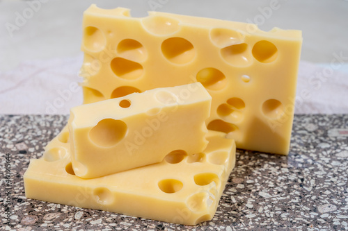 Cheese collection, semi-hard French cheese emmentaler with round holes made from cow milk photo