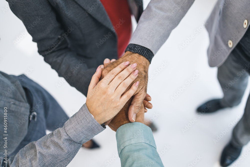 High Angle Shoot Of A Group Unrecognizable Business People Joining Their Hands Together In A Huddle High Angle Shoot Of A Group Unrecognizable Business People Joining Their Hands Together In A Huddle