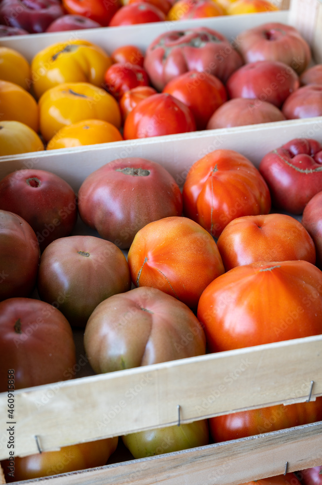 Tasty big ripe french tomatoes in wooden boxes on farmers market in Provence Tasty big ripe french tomatoes in wooden boxes on farmers market in Provence