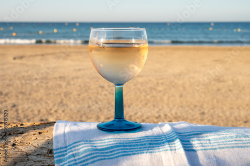 Summer time in Provence, drinking of cold gris rose wine on sandy beach and blue sea near Toulon, Var department, France