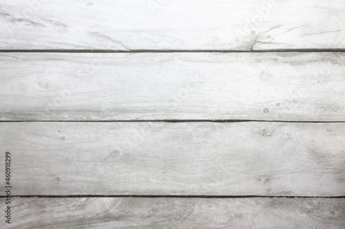 Light grey wooden plank floor with tree branches and stripes. Light gray background with wooden texture. 