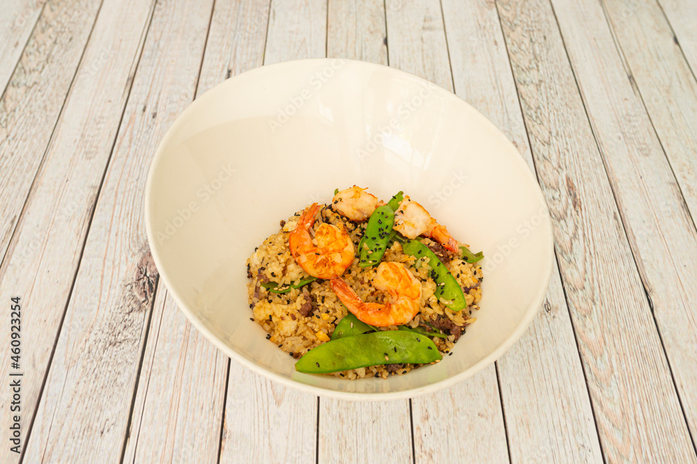 Bowl of Japanese teppanyaki fried rice with sesame seeds with green beans, fried shrimp and sauce Bowl of Japanese teppanyaki fried rice with sesame seeds with green beans, fried shrimp and sauce