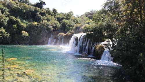 Cascading waterfall with powerful streams of water among the green forest, National Park Krka, Dalmatia, Croatia