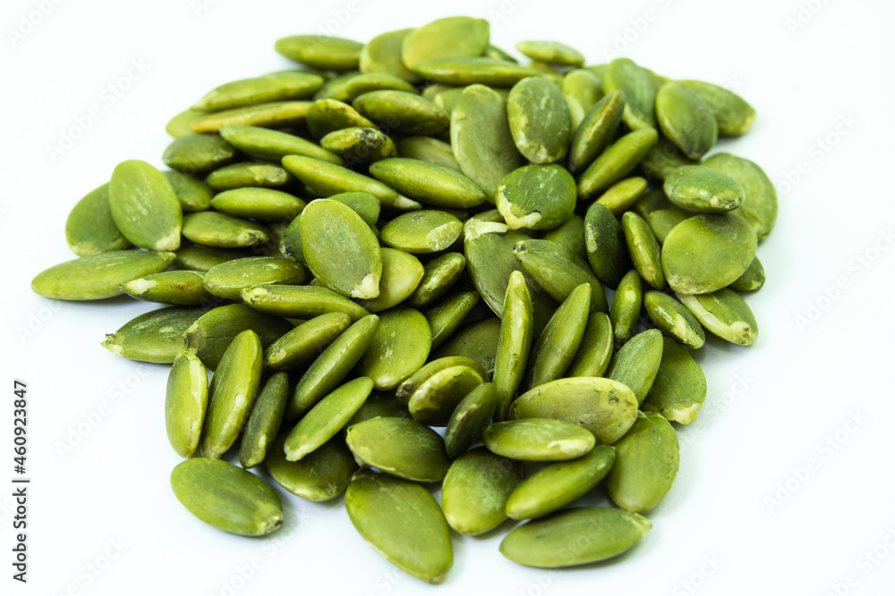 Heap of peeled raw pumpkin seeds isolated on white background Heap of peeled raw pumpkin seeds isolated on white background
