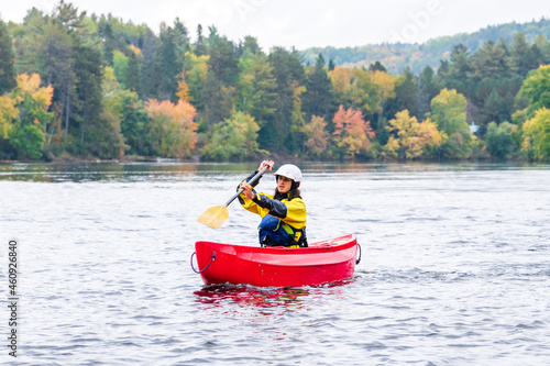 A solo canoeist practices stroke techniques on a rainy fall day as part of a “moving water” paddling course. Shot on the Madawaska River an iconic paddling destination in Eastern Ontario, Canada. © Michael Connor Photo