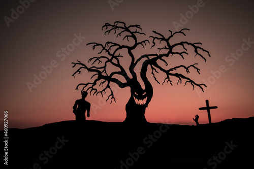 Silhouette some zombies on the cemetery walking around at sunset. Selective focus