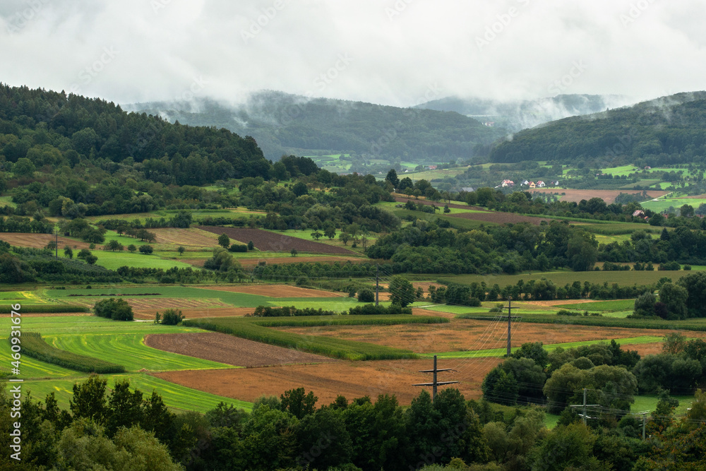 View of mountains and fields in Franconian Switzerland near Ebermannstadt in the fog