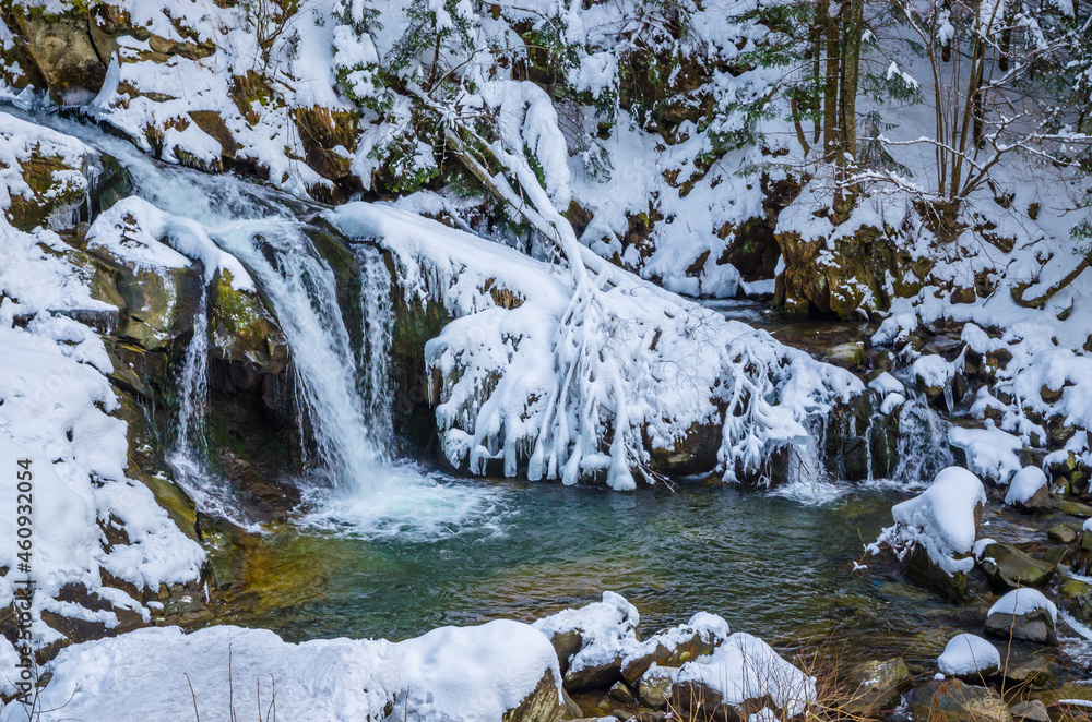 Obraz premium Beautiful mountain river waterfall in winter