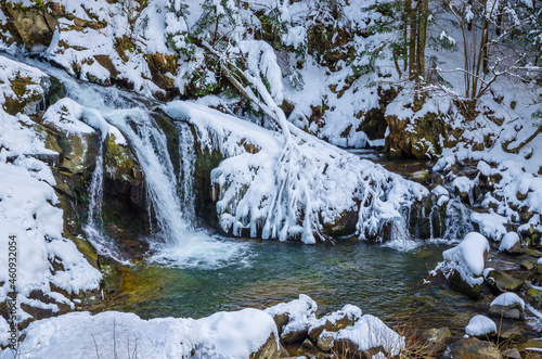 Beautiful mountain river waterfall in winter
