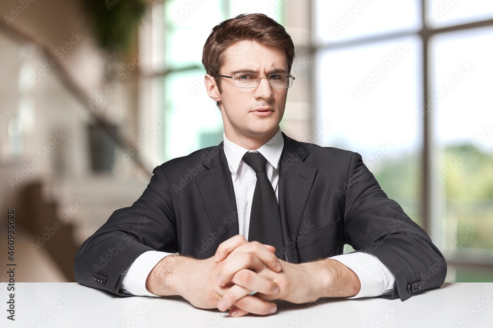 Company executive, owner in formal suit standing at work desk, meeting, interview, negotiation. Company executive, owner in formal suit standing at work desk, meeting, interview, negotiation.