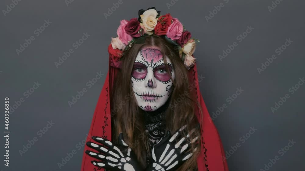 portrait of a girl with Halloween makeup, sugar mexican skull on a gray background portrait of a girl with Halloween makeup, sugar mexican skull on a gray background