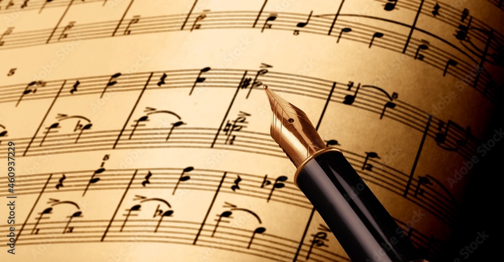 Fototapeta premium writing musical notes on sheet with quill pen and ink. music concept