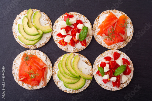 Rice cake with  salmon avocado mozzarella  and tomatoes