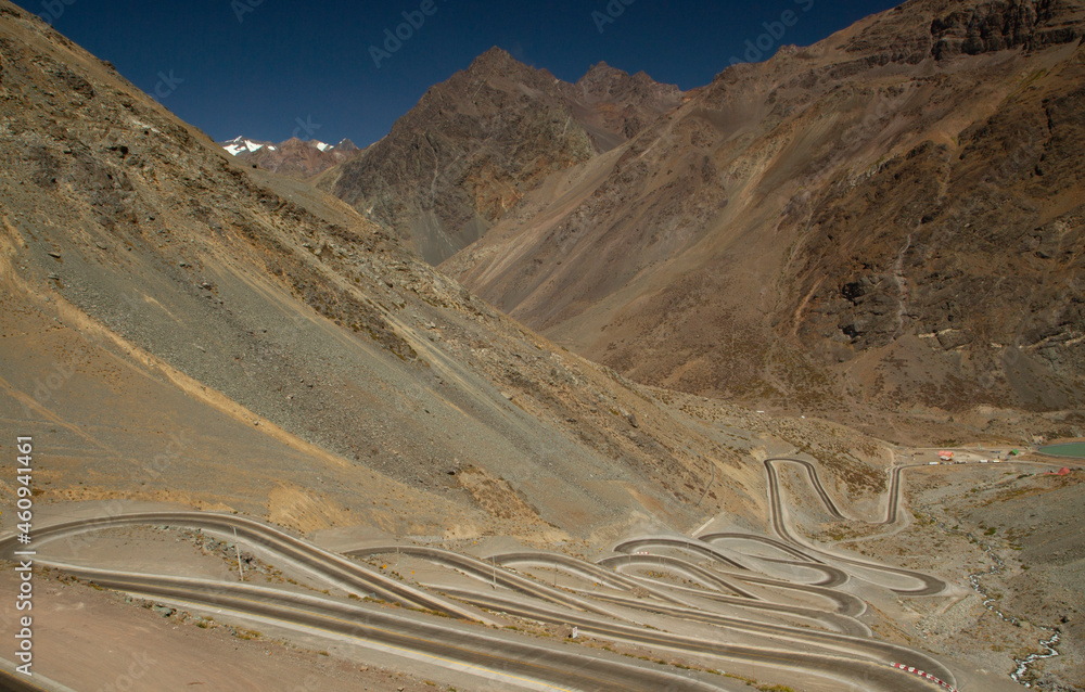 View of the empty asphalt road with many curves, across the mountains and desert. 