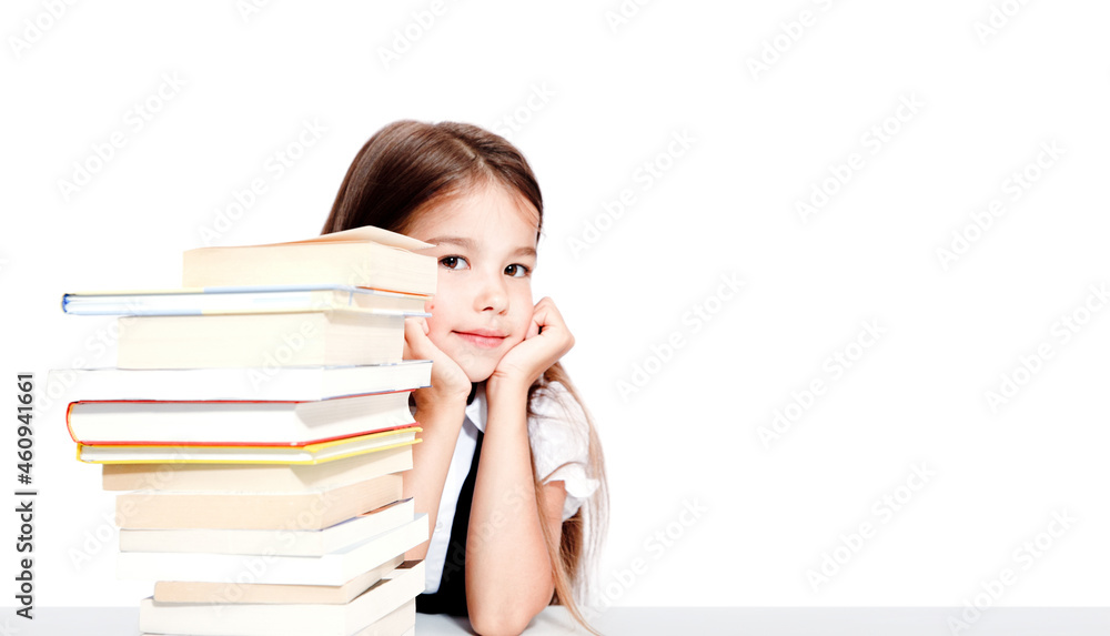 Young cute girl sitting at the table and reading a book Young cute girl sitting at the table and reading a book