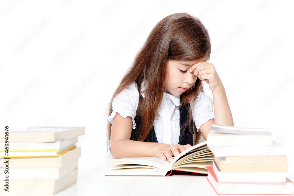 Tired little child girl sleeping on the desk at school. Tired little child girl sleeping on the desk at school.
