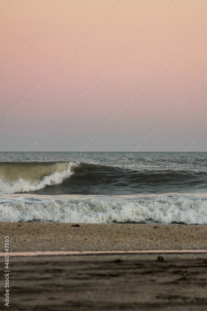 waves at the beach at sunset