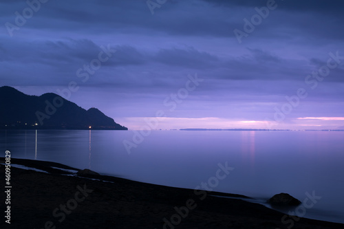 relaxing purple view of the lake llanquihue beach in a cloudy sunset photo