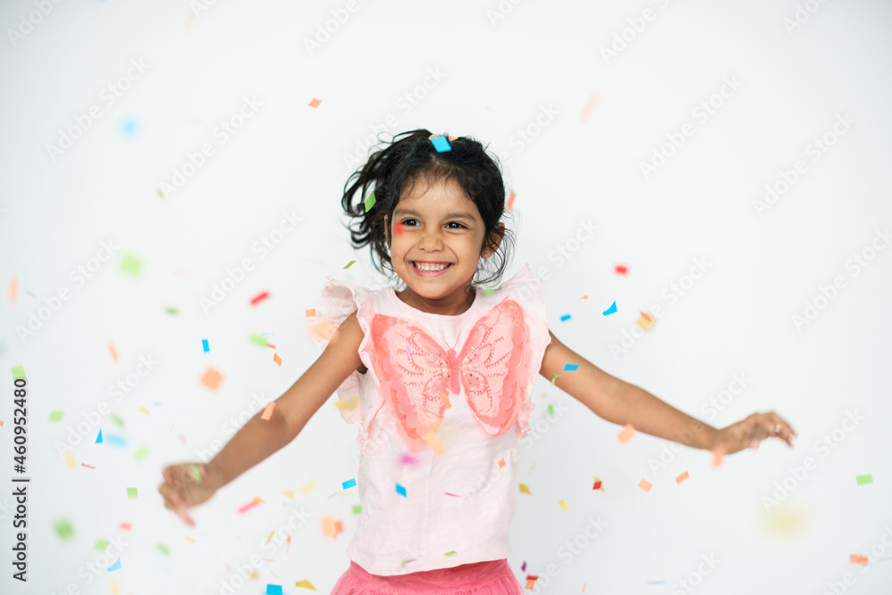 Cute girl dancing in confetti