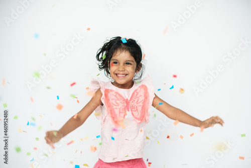 Cute girl dancing in confetti