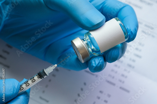 Billede på lærred doctor's hand holds a syringe and a blue vaccine bottle at the hospital