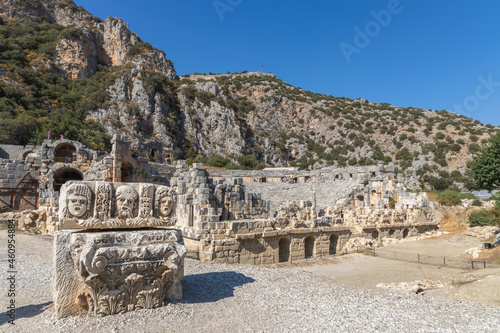 Historical Stone faces bas relief and ancient theater at Myra ancient city. Rock-cut tombs Ruins in Lycia region, Demre, Antalya, Turkey. 