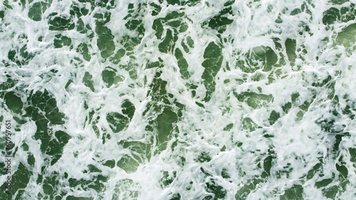 The sea waves that are hitting the shore Taken from a high angle with a drone
