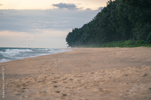 Footprints on the sandy beach and the sun is going down