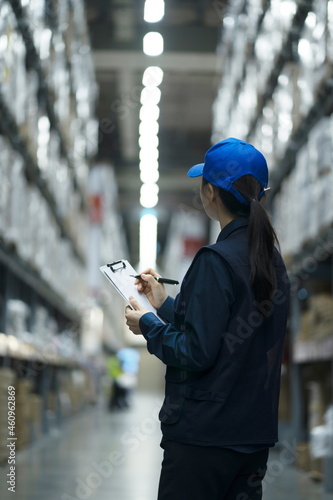 Warehouse worker taking inventory in logistics warehouse