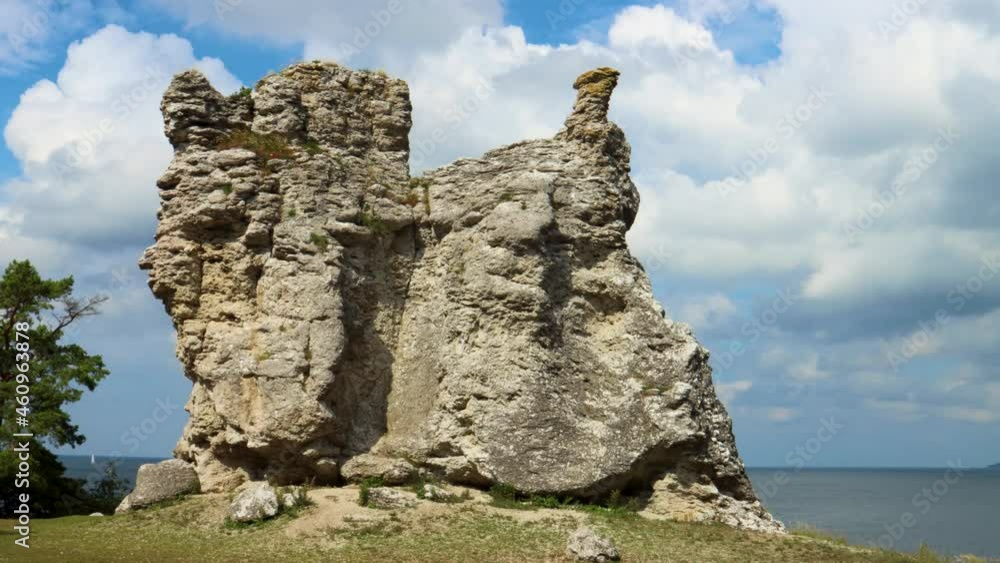 Timelapse of clouds making sun flash by rauk cliff, Gotland, Sweden