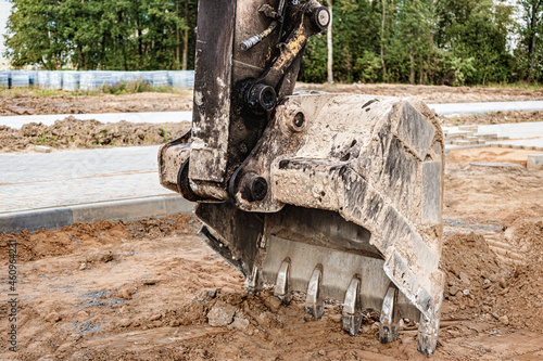 Excavator bucket close up. Excavation work at construction site and road construction. Construction machinery.