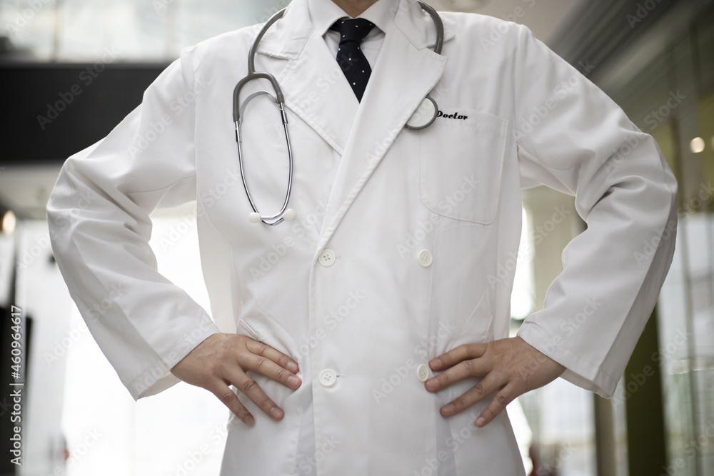 Confident doctor standing at hospital corridor Confident doctor standing at hospital corridor
