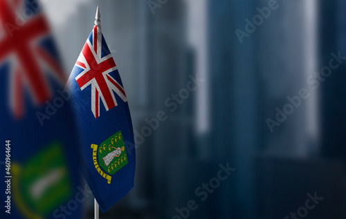 Small flags of British Virgin Islands on a blurry background of the city