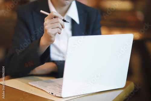 Businesswoman using laptop on table in cafe