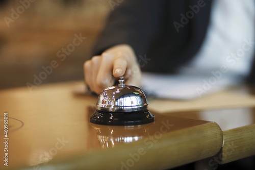 Close up of businesswoman using hotel bell
