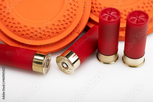 Clay shooting target with shotgun shells on white isolated background , Shotgun game