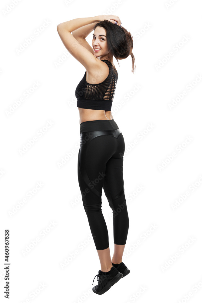 Fototapeta premium Beautiful smiling woman in sportswear. Active lifestyle and health. Full height. Isolated on white background. Vertical.