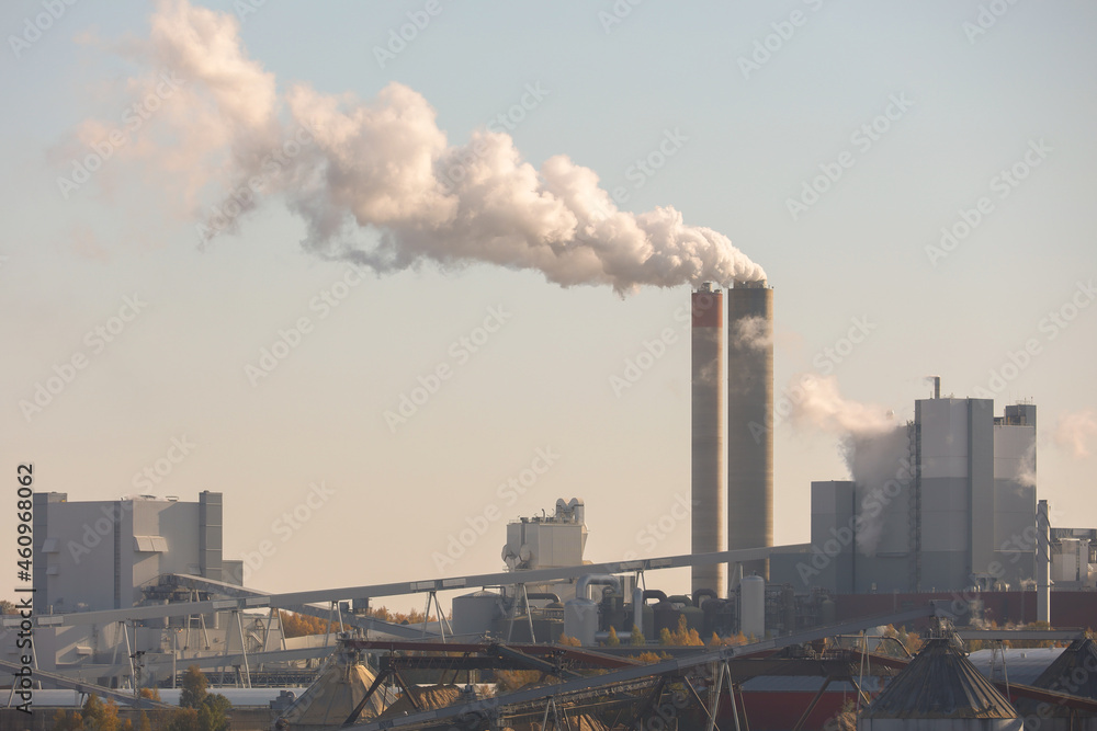 Smoke from the chimneys of the factory. Air pollution in the environment