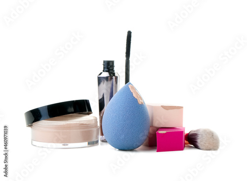 Stylish makeup sponges and decorative cosmetics on white background
