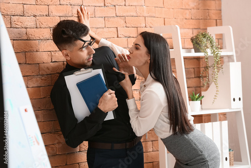 Fotografie Beautiful young secretary seducing her boss in office