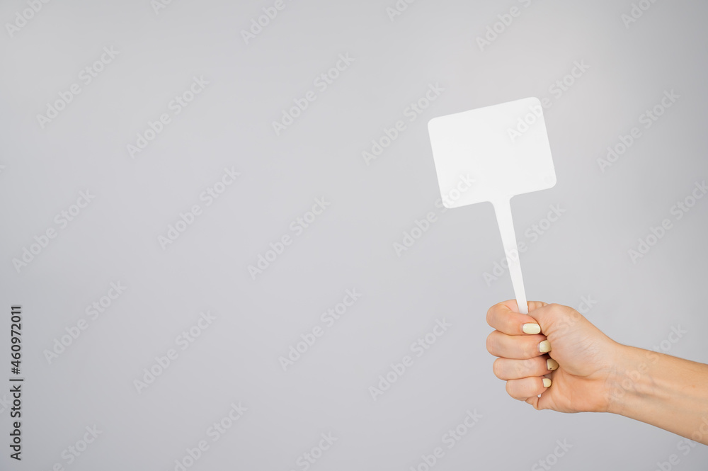 Woman holding blank sign on white background. Copy space. Woman holding blank sign on white background. Copy space.