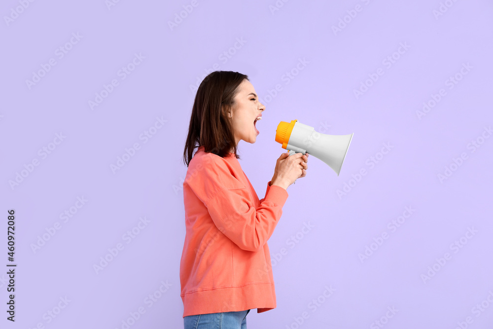 Protesting young woman with megaphone on color background Protesting young woman with megaphone on color background